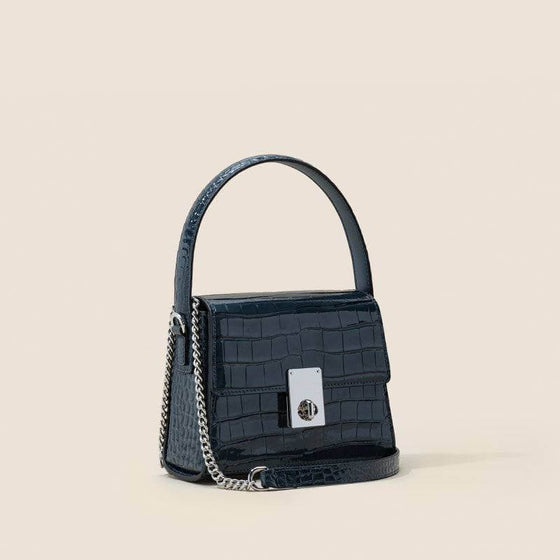 Leather handbags portable diagonal bag with single shoulder strap and trapezoid shape.