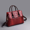 Ladies tote shoulder messenger handbag in red crocodile pattern with PU material and multiple compartments.