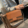 Leather handbags with retro design and spacious interior, featuring belt decoration and contrast color.