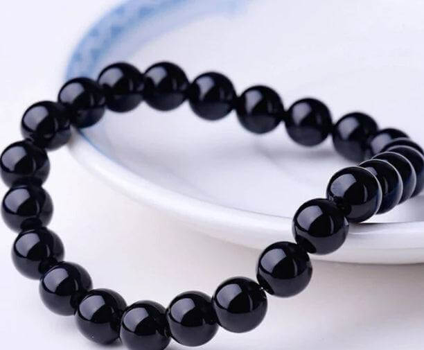 Black Onyx BraceletExperience the power of the Black Onyx Bracelet. Made with an imported elastic cord and featuring 8MM geometric black agate beads, this bracelet is not just stylish BraceletPlush Fashions ShopPlush Fashion ShopBlack Onyx Bracelet