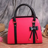 ETUDE shark summer version bow lady handbag in pink with black accents.