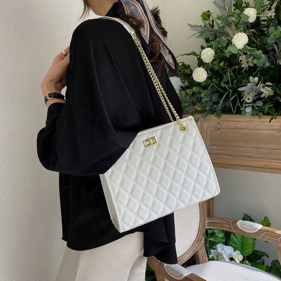 Women's stylish large-capacity tote handbag in white with quilted embossing.