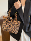 Leopard fluff handbag with zip, showcased in a stylish outfit, perfect for adding luxury and practicality to any look.